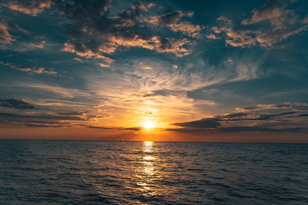 body of water under blue sky during sunset