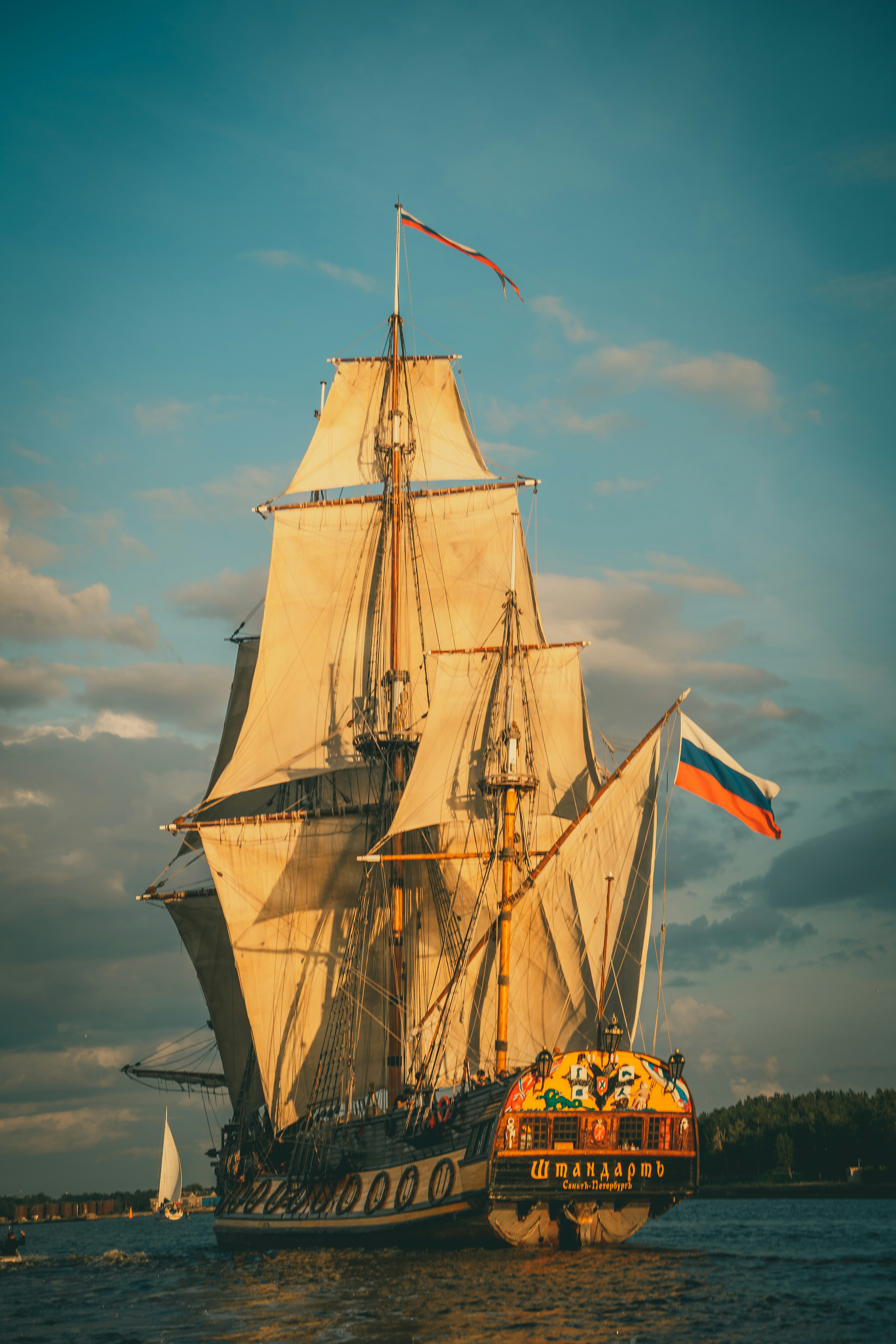The Frigate Shtandart is the exact replica of the man-of-war built by Peter the Great in 1703 in order to defend Saint Petersburg. The Frigate Shtandar in calm weather sailing sunset time Riga Latvia