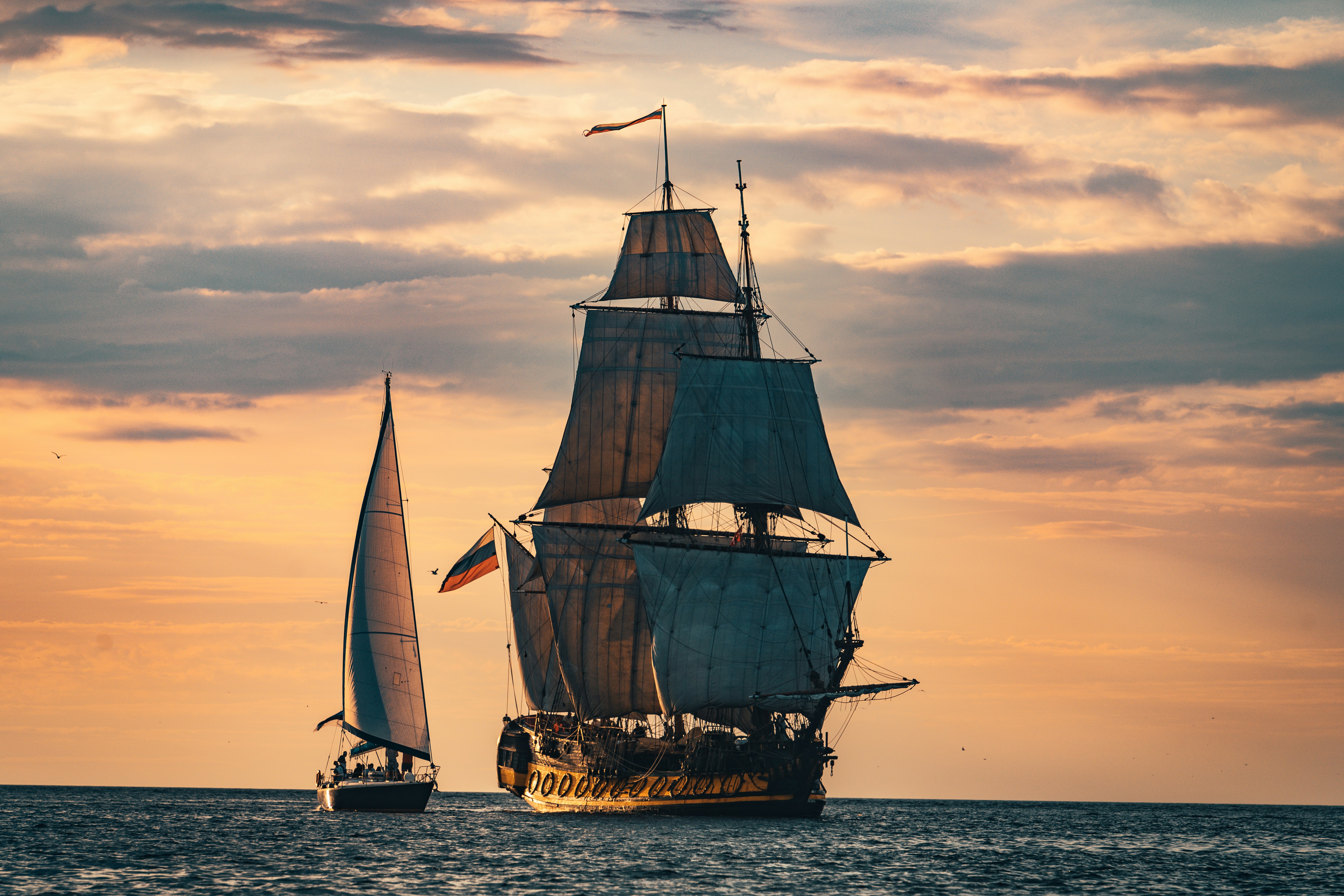 The Frigate Shtandart is the exact replica of the man-of-war built by Peter the Great in 1703 in order to defend Saint Petersburg. The Frigate Shtandar in calm weather sailing sunset time Riga Latvia
