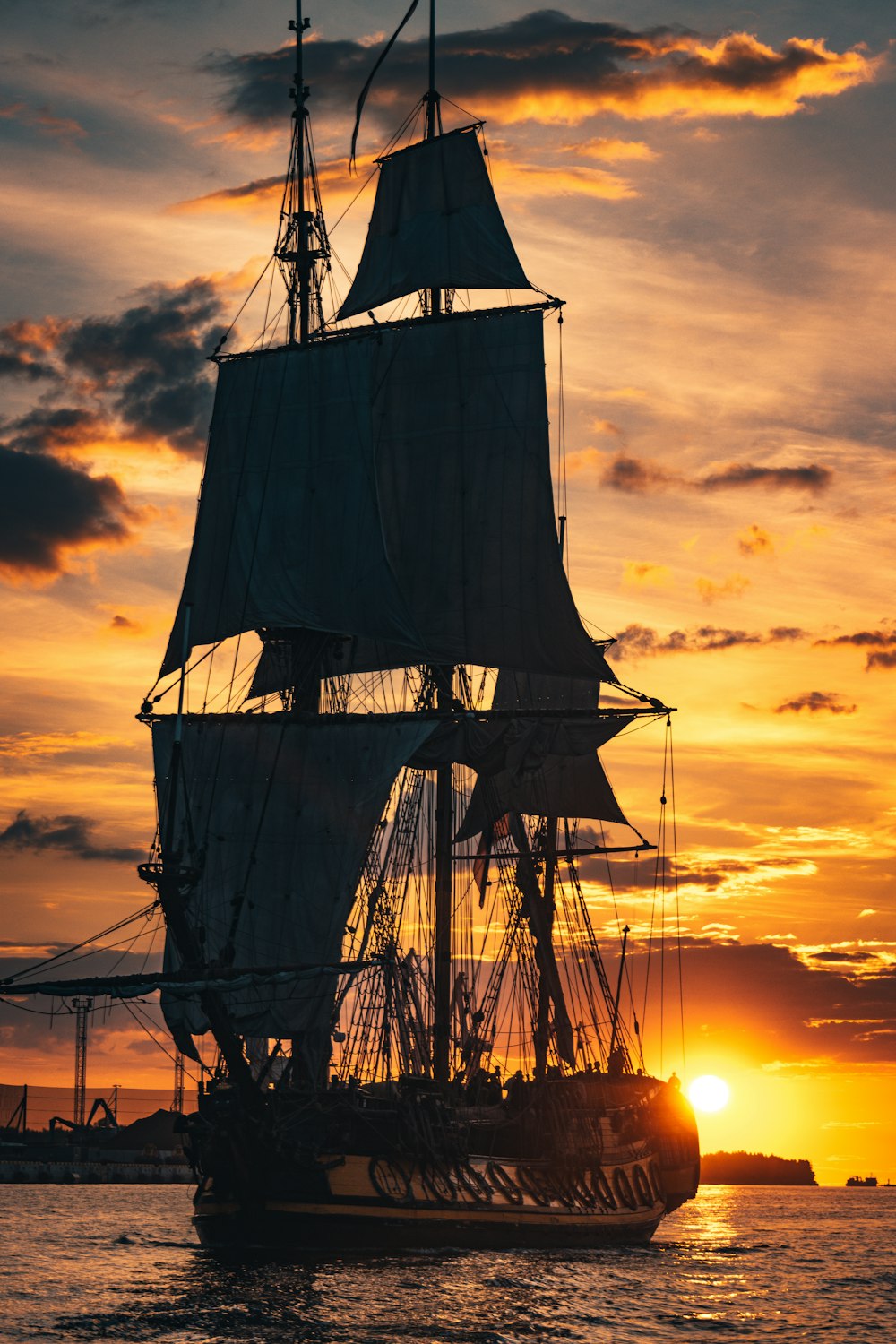 silhouette of ship during sunset