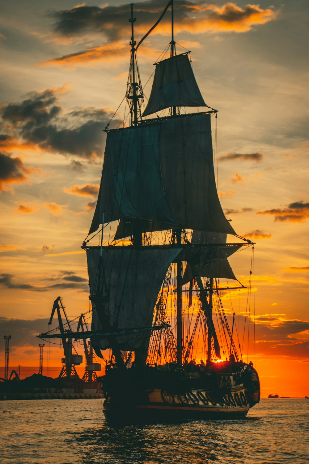 silhouette of ship during sunset
