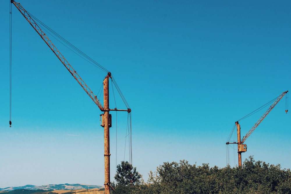 orange crane under blue sky during daytime