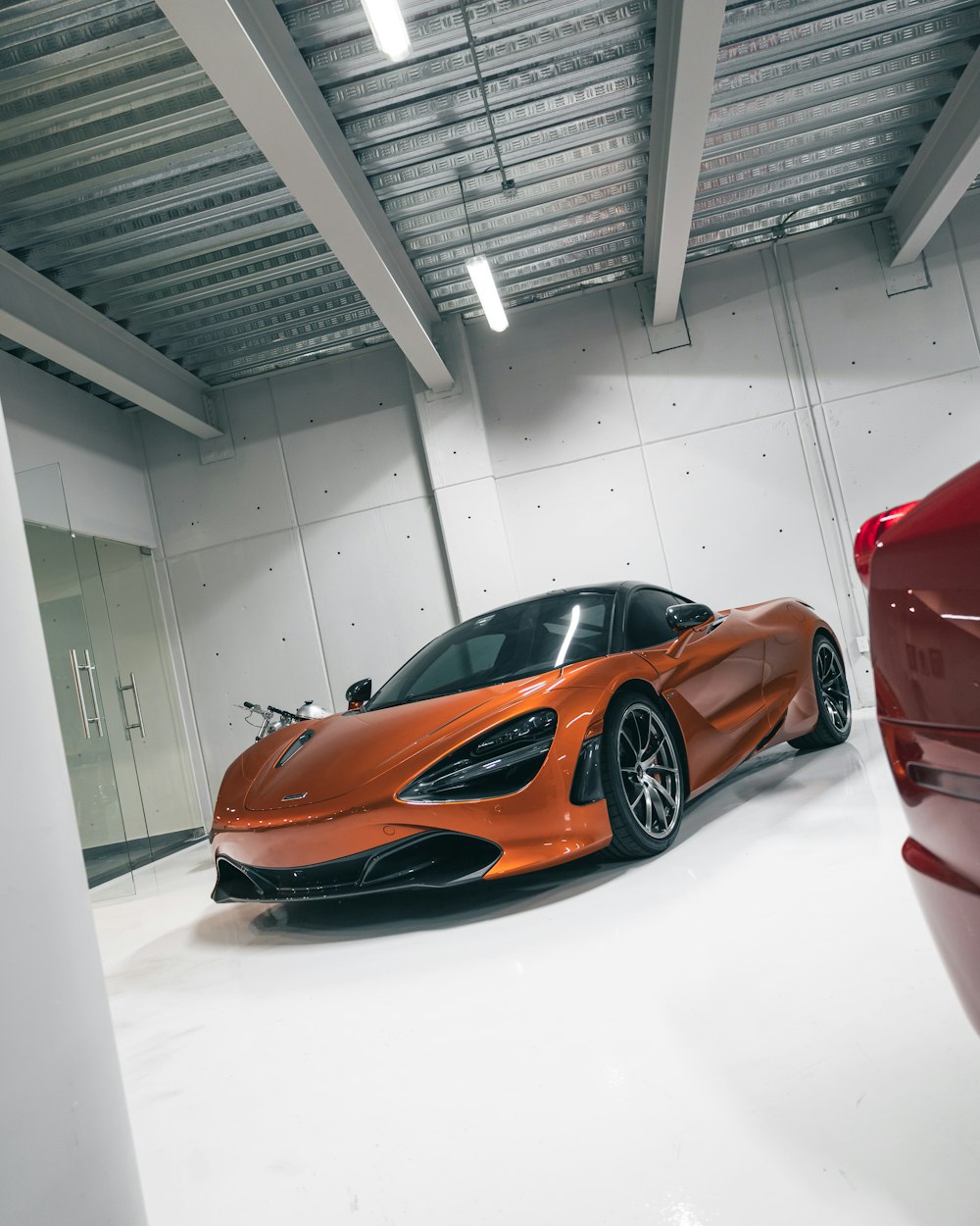 red ferrari 458 italia in a white room