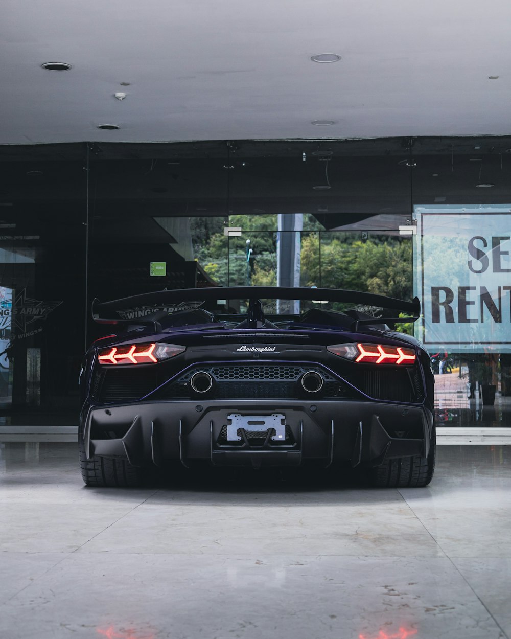 black and red car parked on white floor tiles