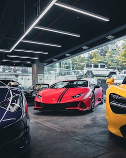 red ferrari sports car parked beside yellow car