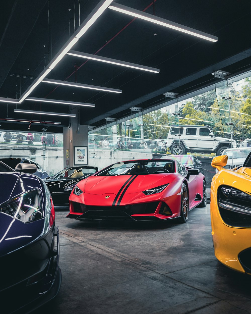 red ferrari sports car parked beside yellow car