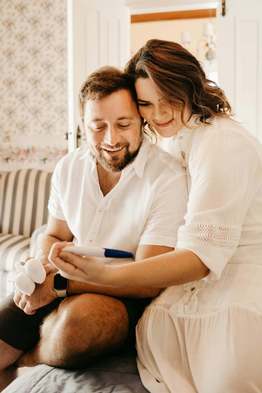 man in white button up shirt sitting beside woman in white shirt