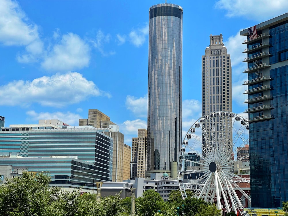 white ferris wheel near city buildings during daytime