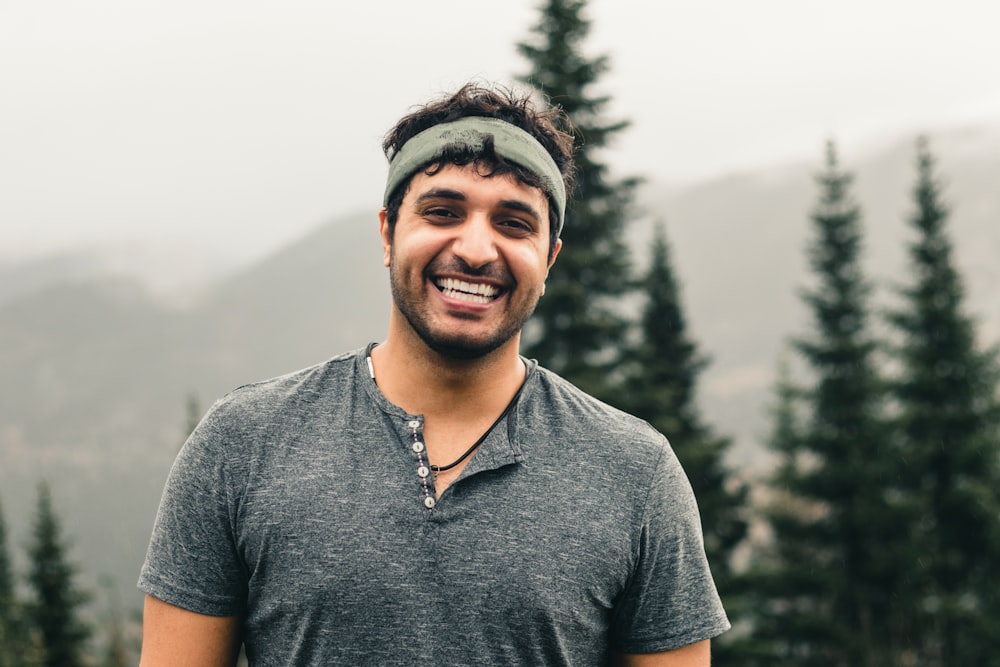 man in gray polo shirt smiling