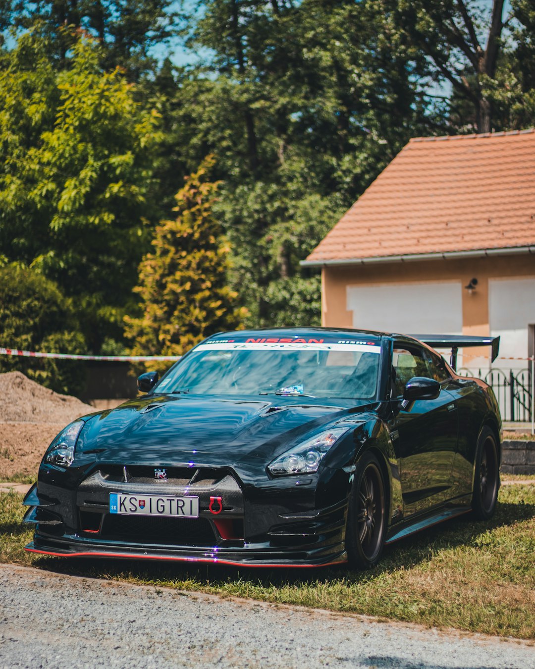 blue bmw m 3 coupe parked near brown wooden house during daytime