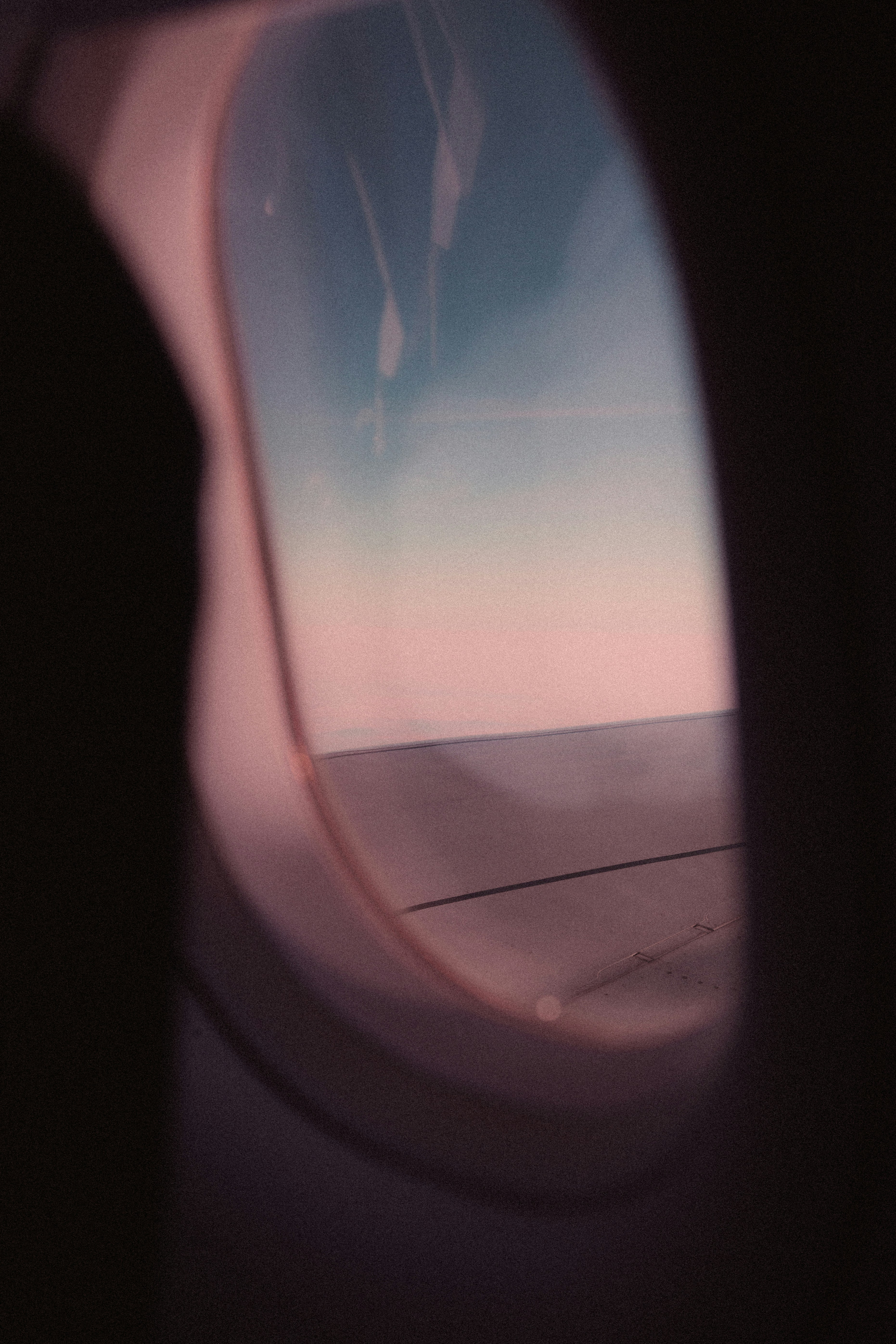 airplane window with a view of white clouds during daytime