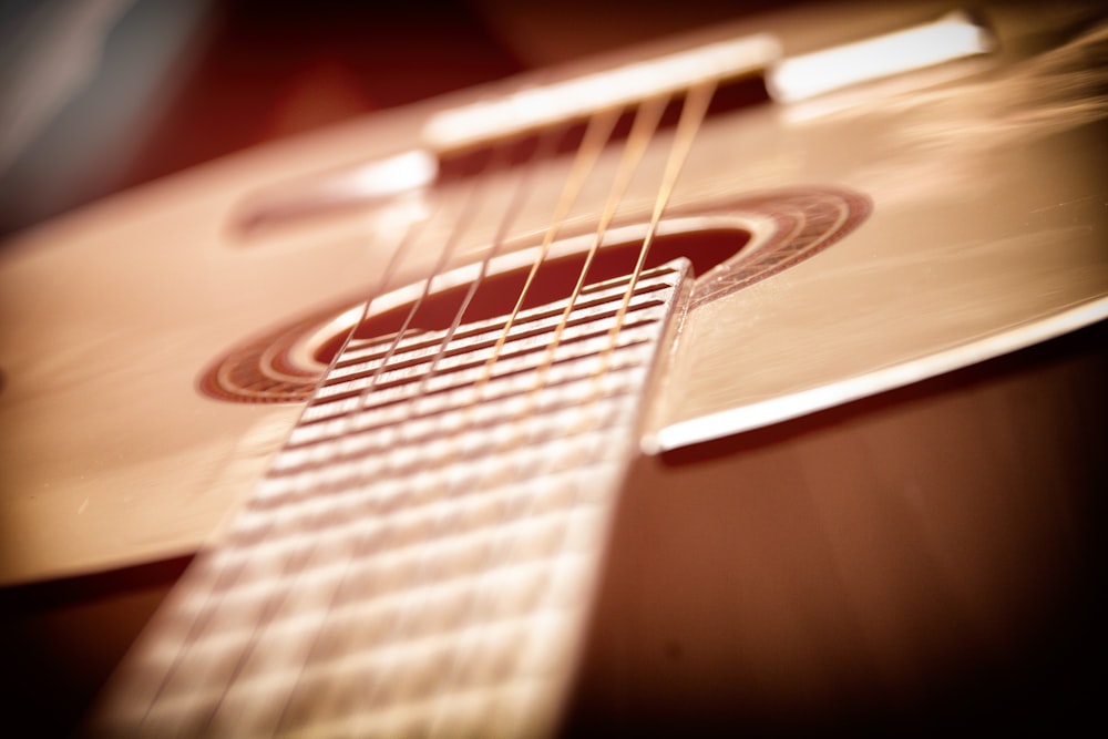 brown and white acoustic guitar