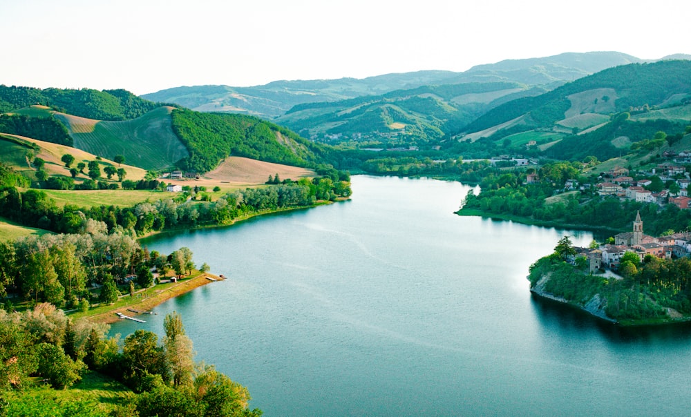 green mountains beside lake during daytime