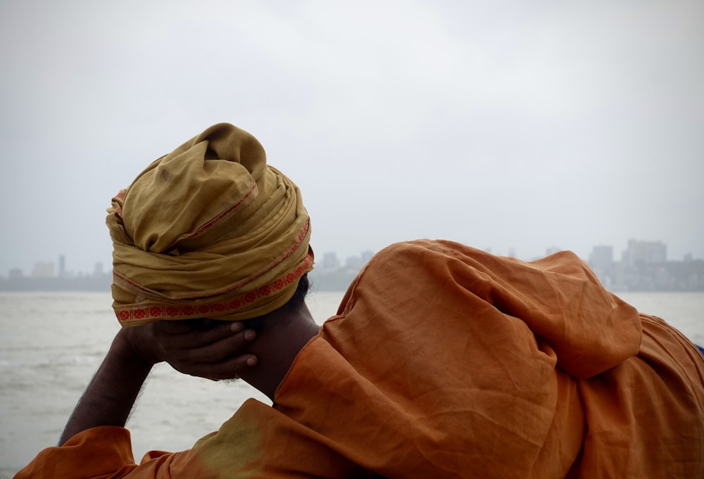 person in brown hijab covering face with brown textile