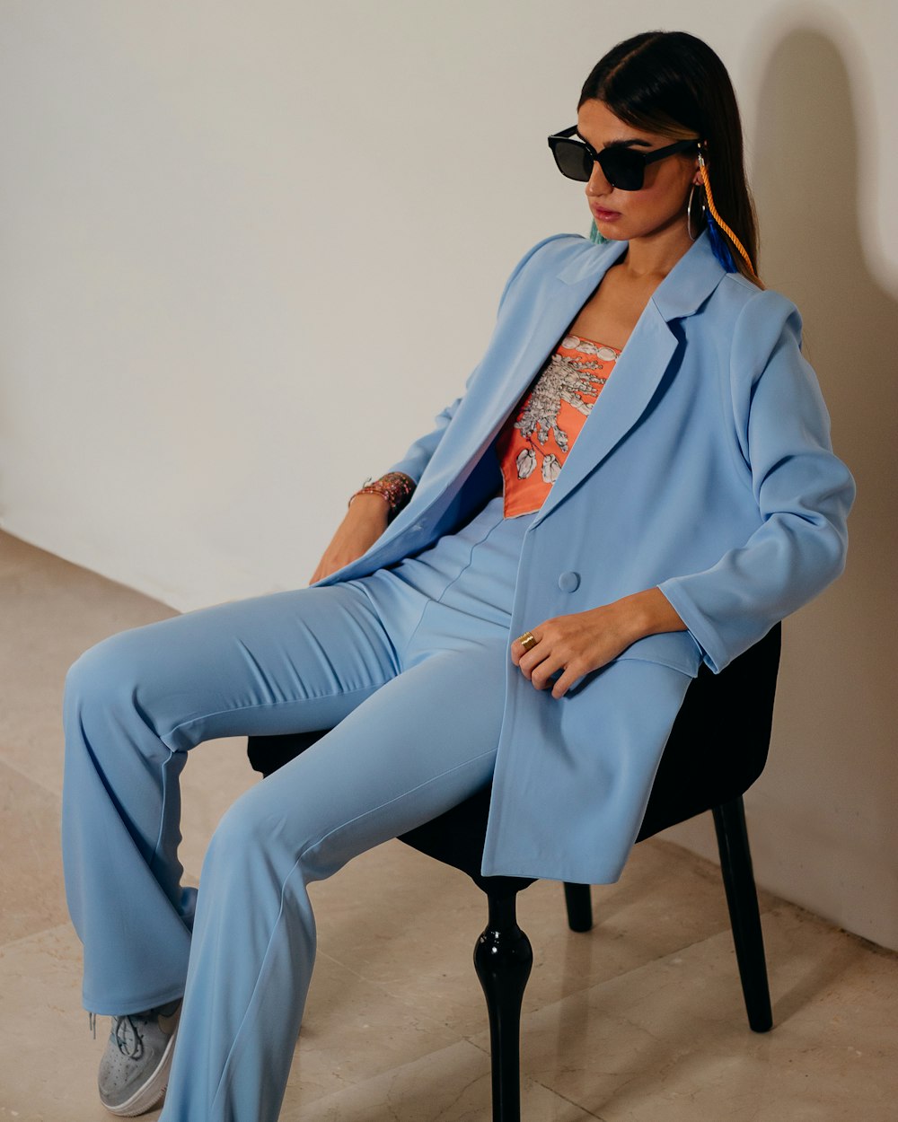 woman in blue blazer and blue denim jeans sitting on chair