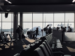 A friendly staff member assisting a student at the airport.