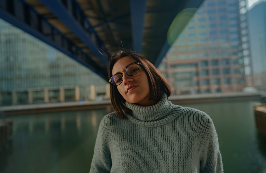 woman in gray turtleneck sweater wearing black framed eyeglasses