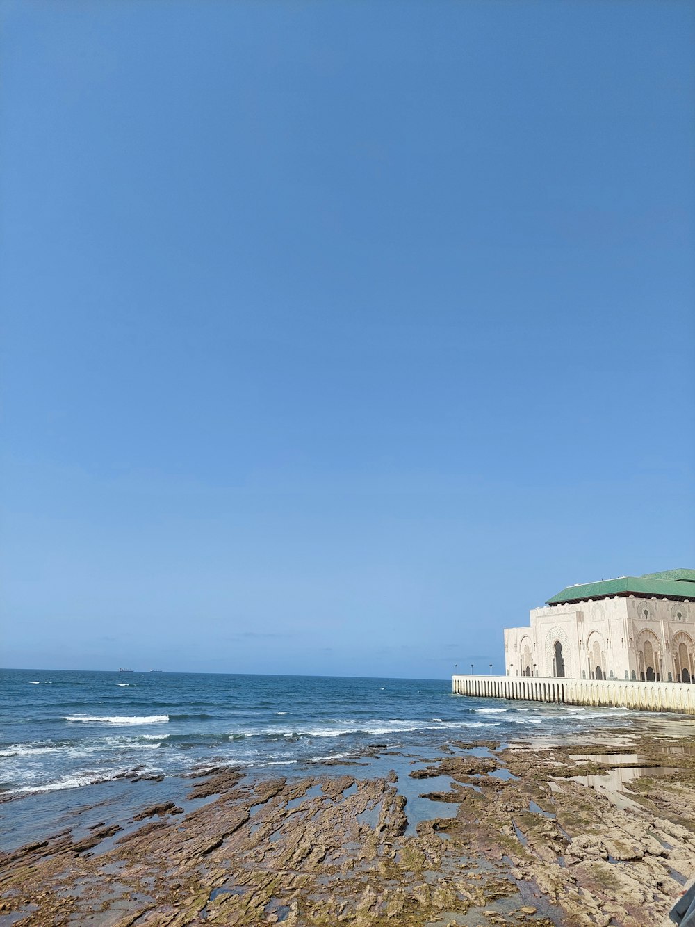 green concrete building near sea during daytime