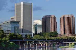 white and blue high rise building near body of water during daytime