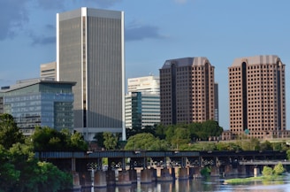 white and blue high rise building near body of water during daytime