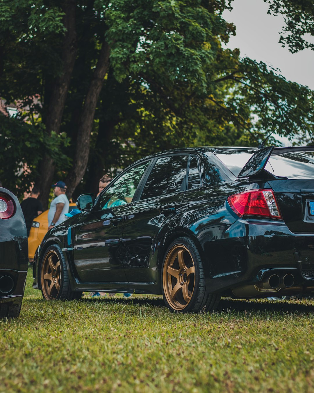 black bmw m 3 coupe on green grass field during daytime