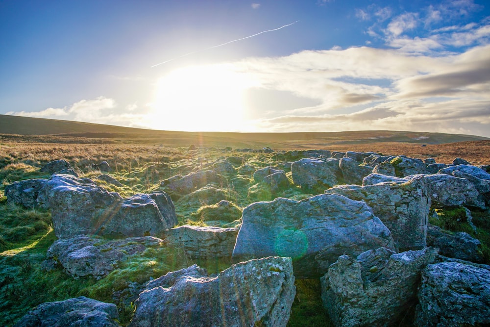 gray and green rock formation under white clouds during daytime