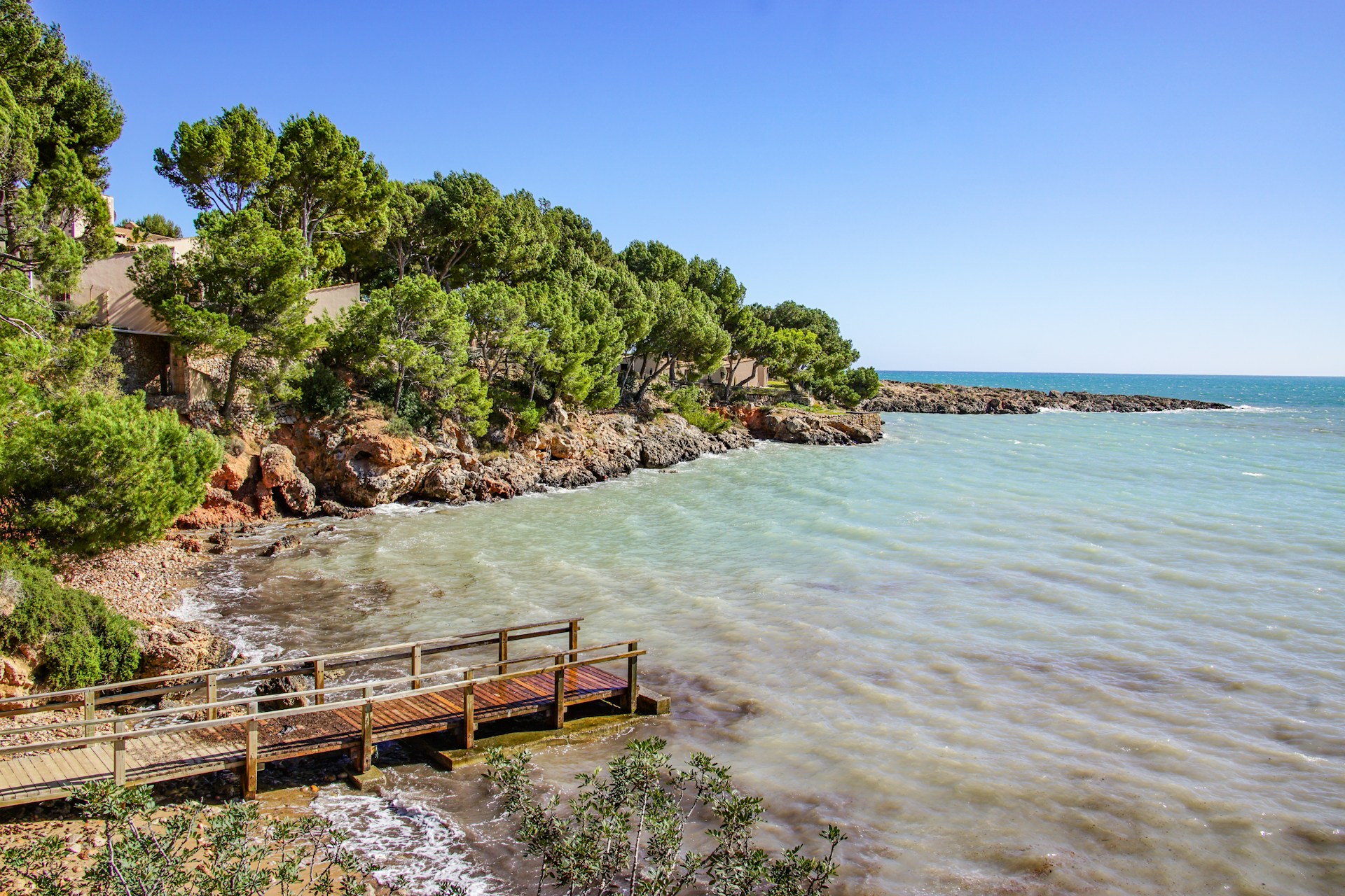 brown wooden dock on body of water during daytime