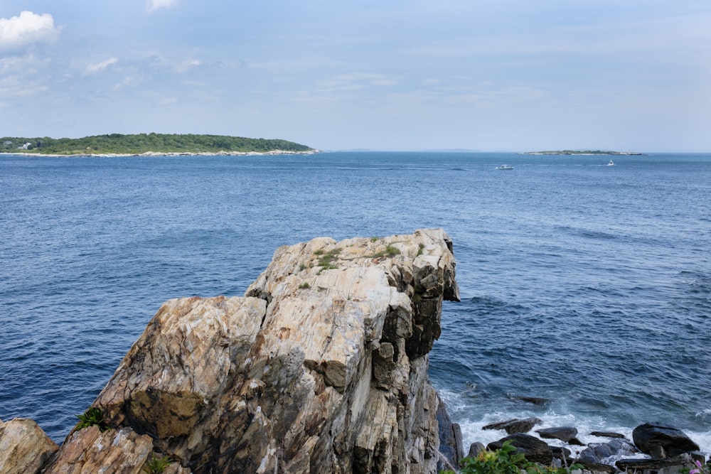 brown rock formation near body of water during daytime