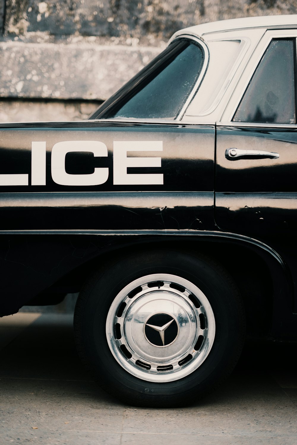 black and white car on gray concrete pavement