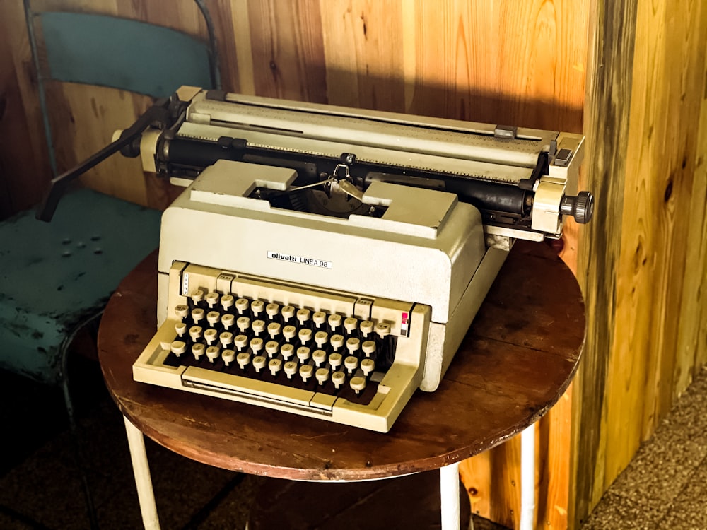 gray and black typewriter on brown wooden table