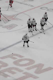 Team members practicing synchronized jumps during a chilly morning session on the ice rink.