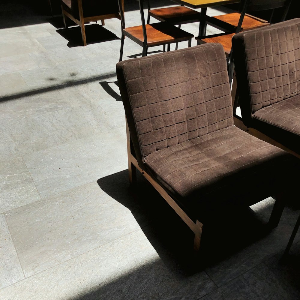 brown wooden armchair on white floor tiles