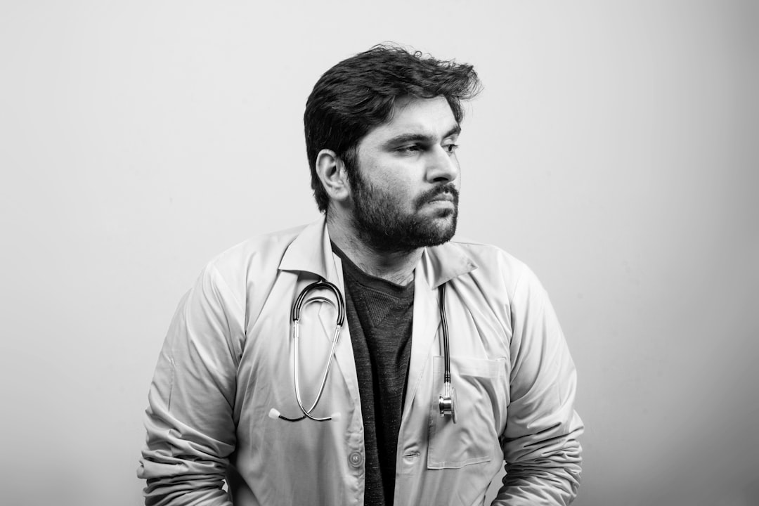 man in white button up shirt, A doctor looking at one side thinking - Black and White