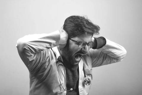 man in gray dress shirt wearing black framed eyeglasses