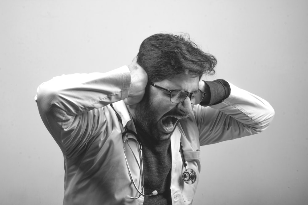 man in gray dress shirt wearing black framed eyeglasses