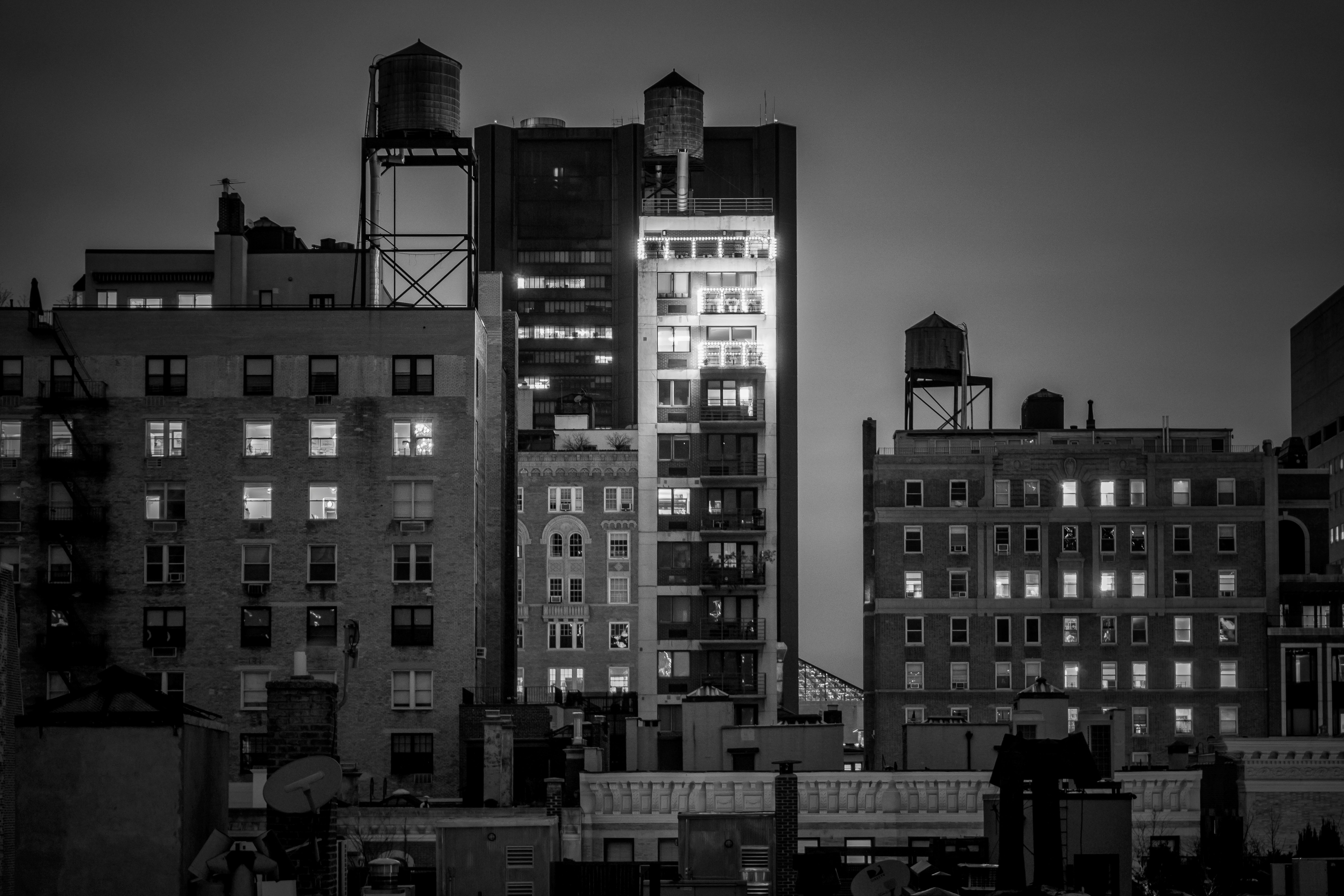 grayscale photo of city buildings during night time