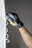 Close-up of hands wearing gloves removing mold from a wall.