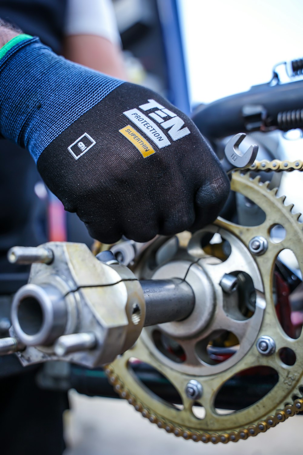 a close up of a person holding a bike chain