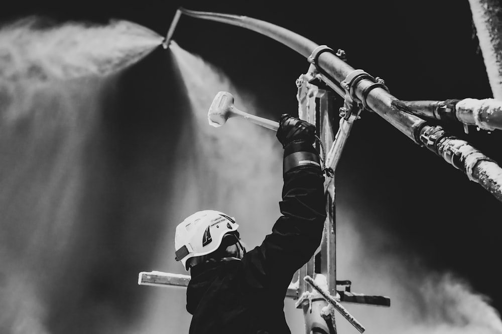 a black and white photo of a person spraying water