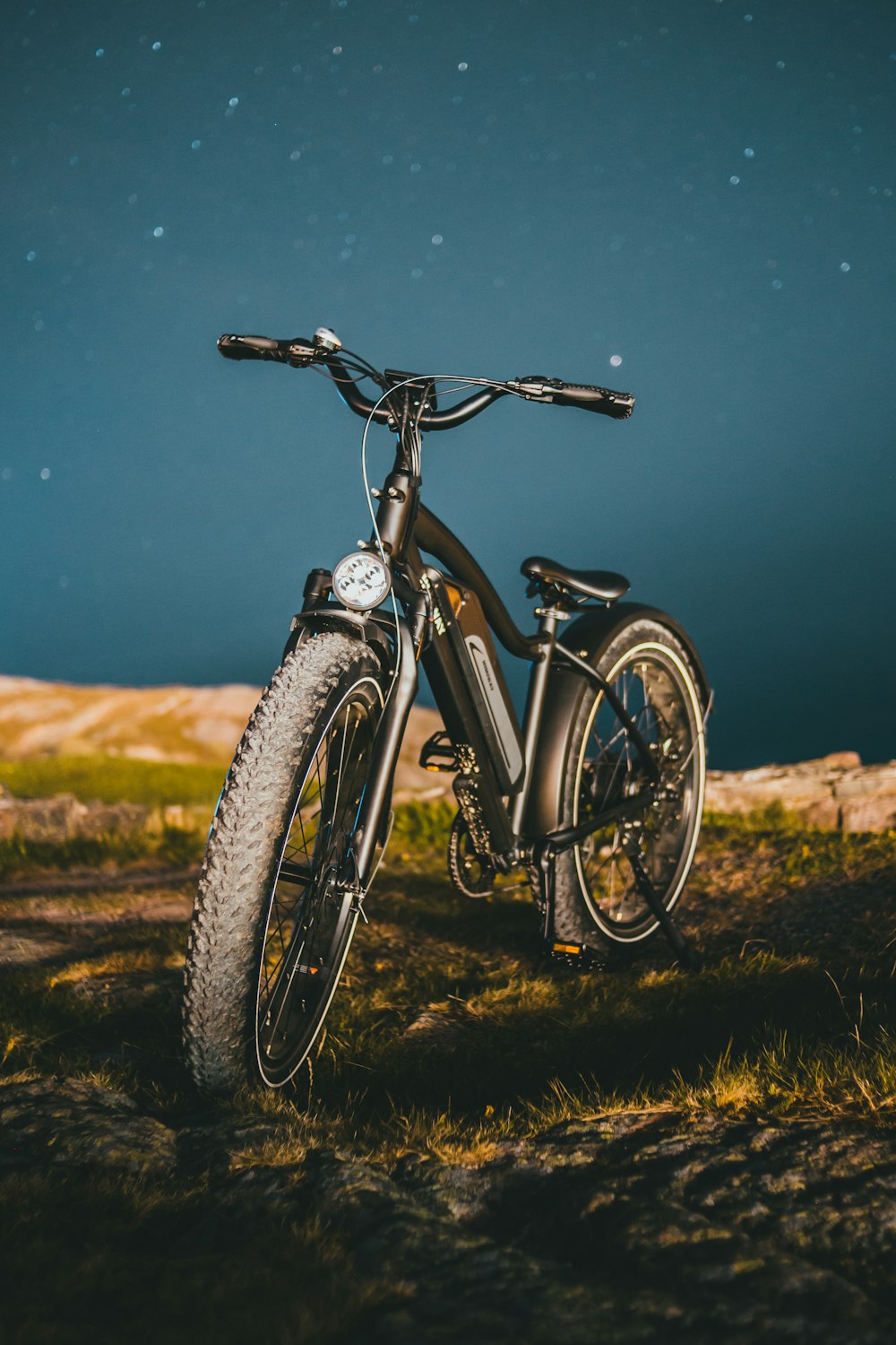 black and white mountain bike on green grass field during daytime