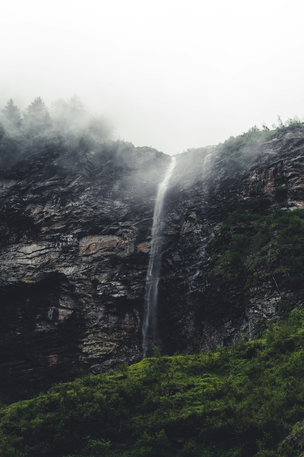 waterfalls on rocky mountain during daytime