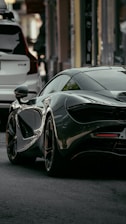 black mercedes benz coupe parked on street during daytime