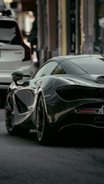 black mercedes benz coupe parked on street during daytime