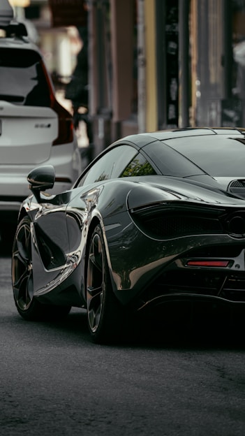 black mercedes benz coupe parked on street during daytime