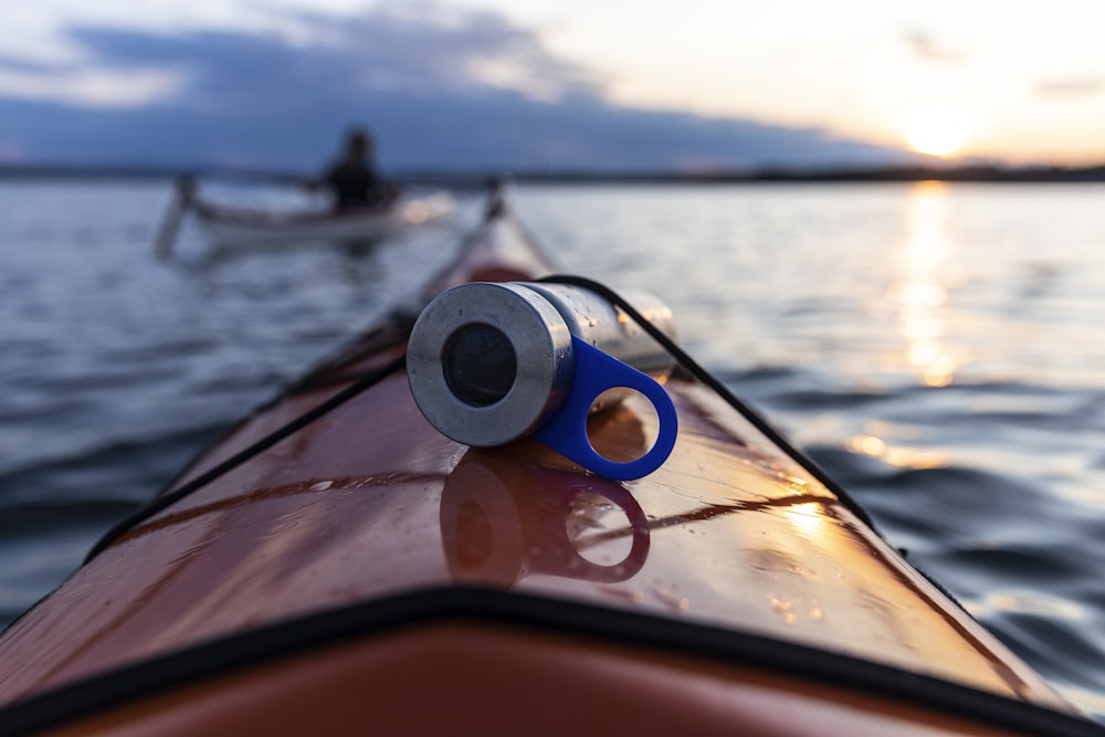 blue and white plastic bottle on brown and black boat