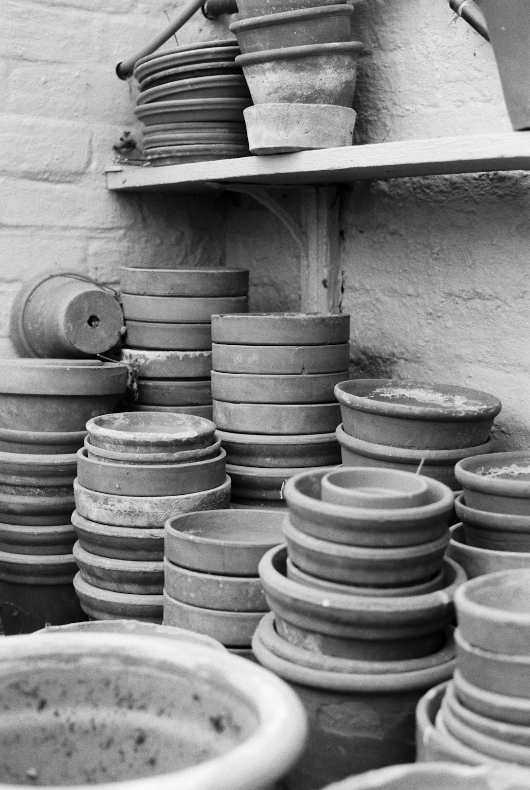 gray round plastic containers on white wooden shelf