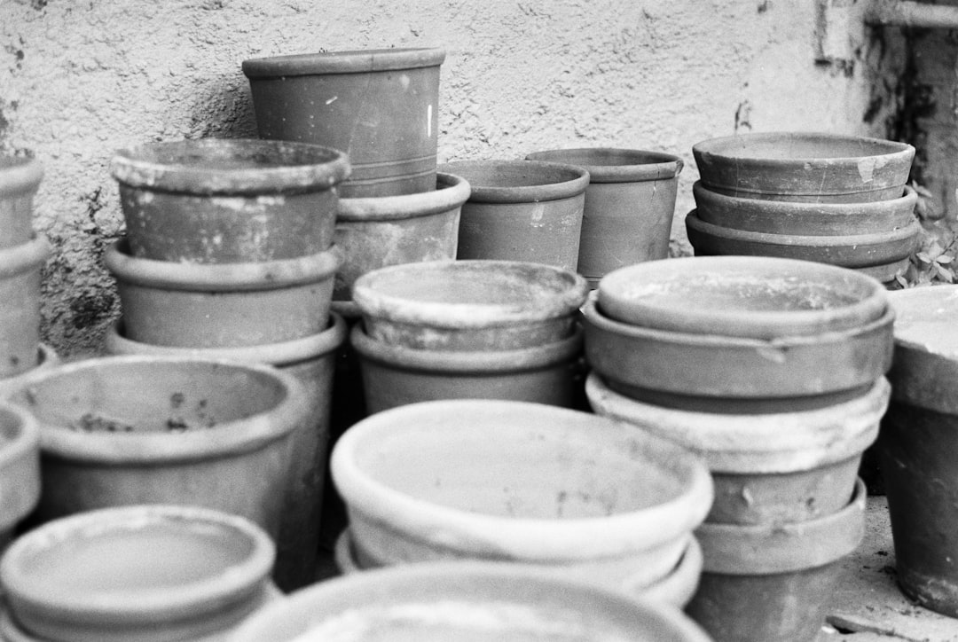 white plastic bucket on gray concrete wall