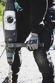 a close up of a person holding a drill