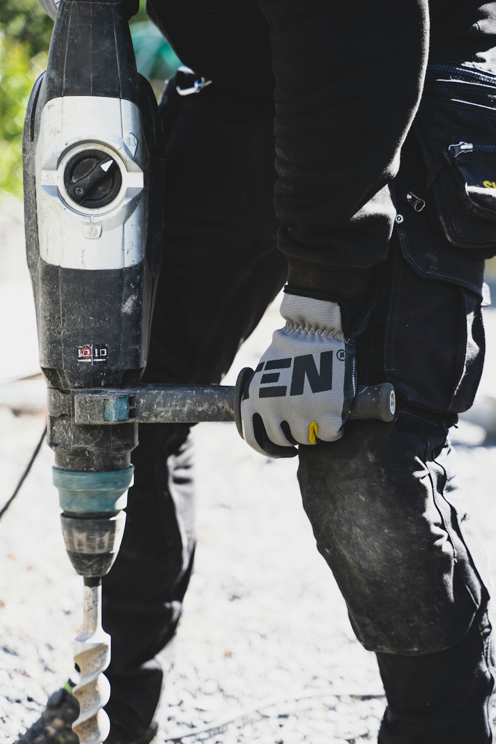 a close up of a person holding a drill