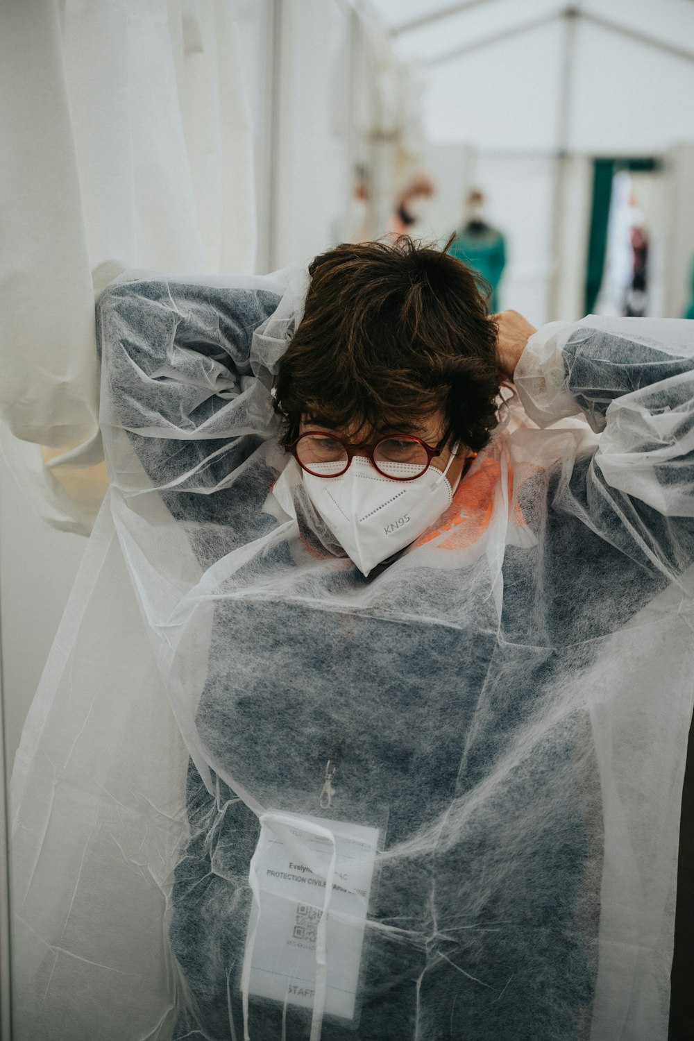 woman in white veil covering her face with white sheer textile